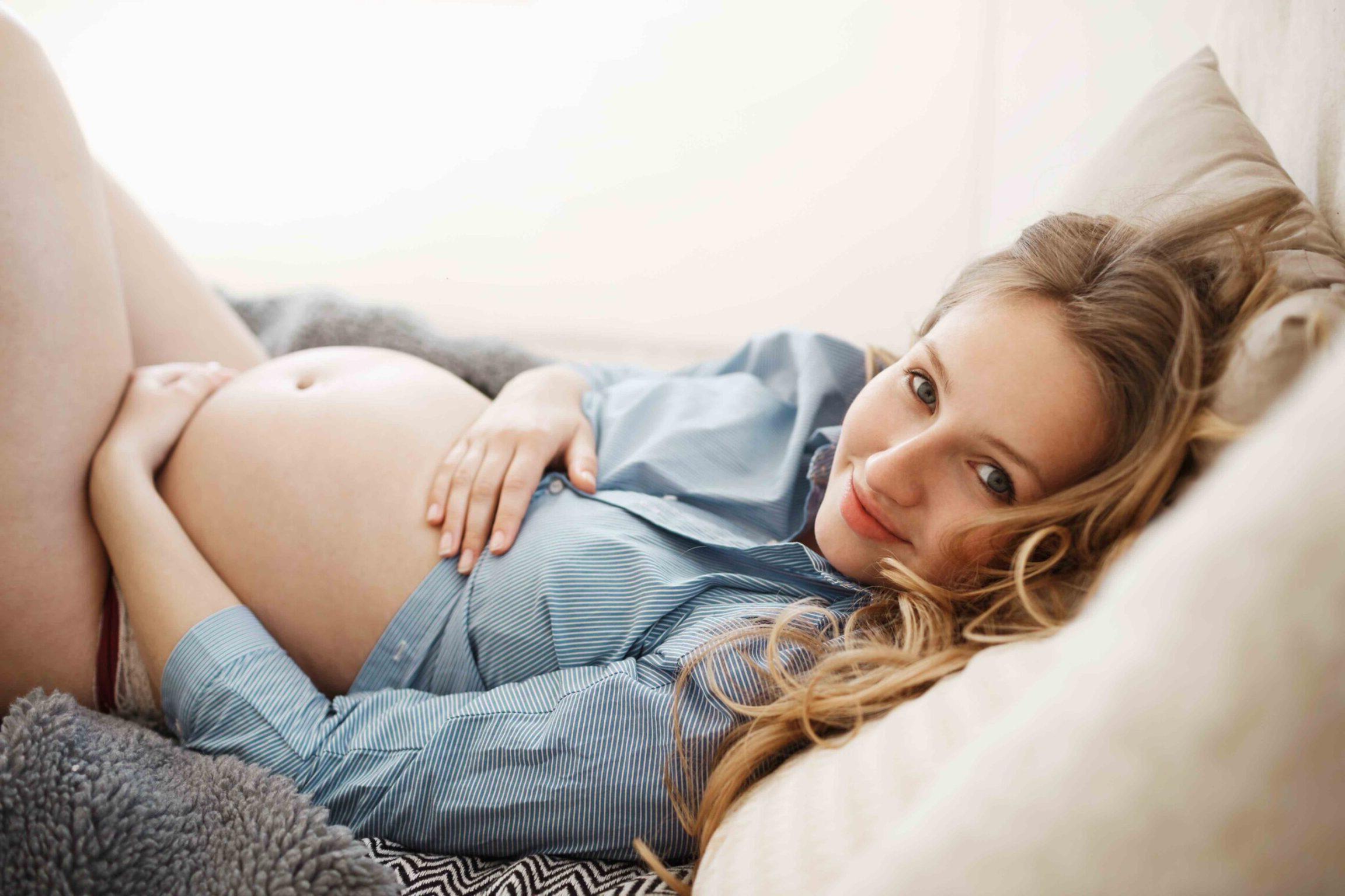 Woman enjoying her pregnancy relaxing in comfy bed